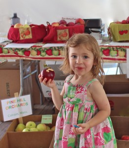 A young girl named Isabeau bites into a William's Pride apple from Red Apple Farm, Phillipston, Massachusetts. at the Farm Fresh Festival. (Bar Lois Weeks photo)