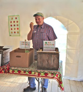 Massachusetts Commissioner of Agriculture John Lebeau samples a PaulaRed apple at Saturday's Farm Fresh Festival. (Bar Lois Weeks photo)