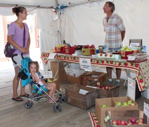 Senior Writer Russell Steven Powell visits with a mother and daughter at Farm Fresh Festival. (Bar Lois Weeks photo)